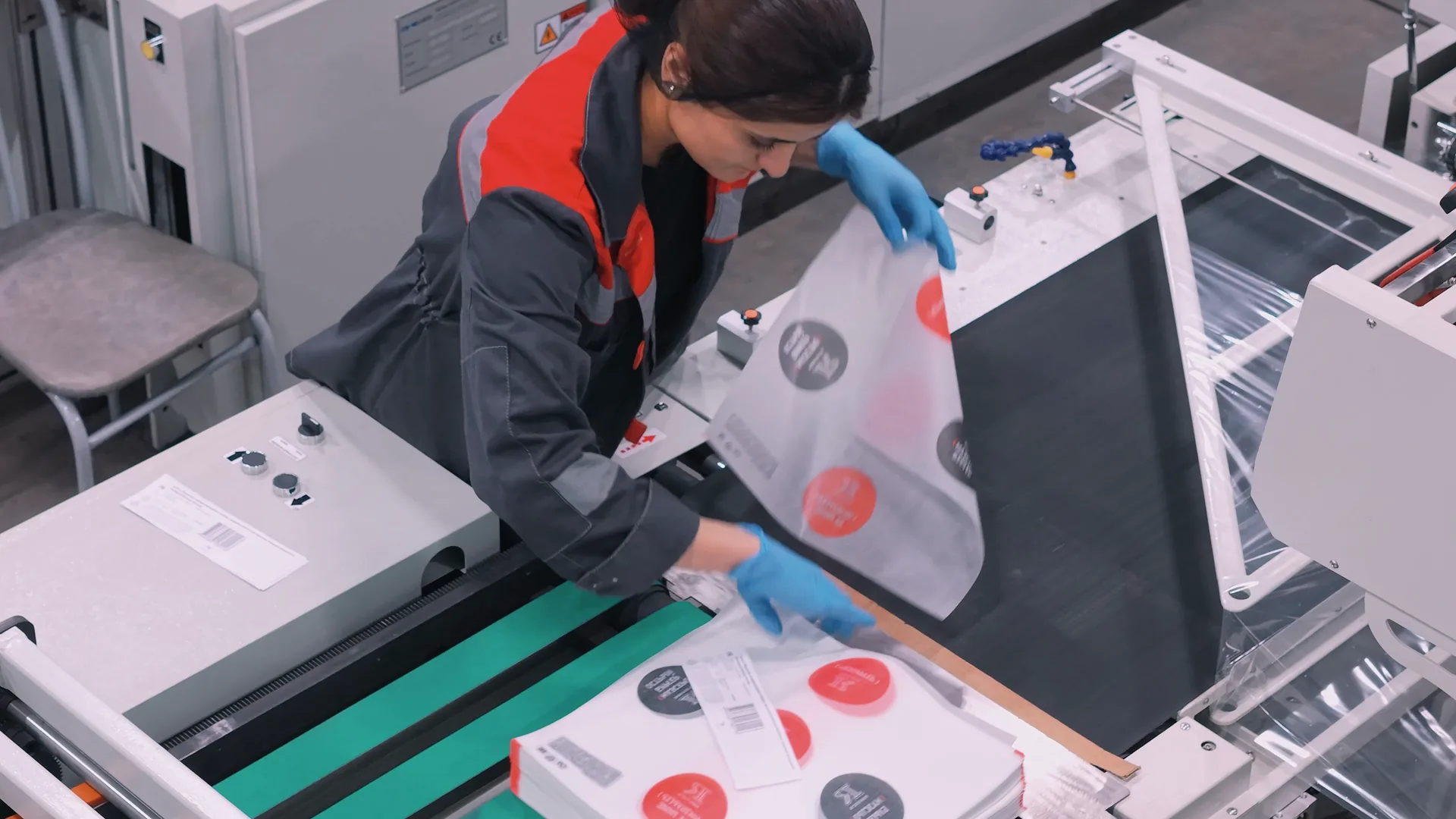 An operator taking finished bags off the line